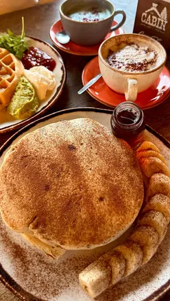 Delicious vegan banana pancakes and matcha latte enjoyed at The Cabin Sheffield, featuring cozy decor and friendly staff.