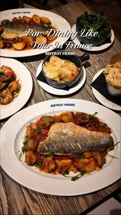 Delicious Sea Bass Provençale, Gambas, and desserts at Bistrot Pierre Leicester, highlighting rich French flavors.