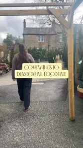 Visitors exploring the diverse food hall at Dunston Hall Estate in Chesterfield, showcasing local delicacies and treats.