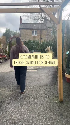 Visitors exploring the diverse food hall at Dunston Hall Estate in Chesterfield, showcasing local delicacies and treats.