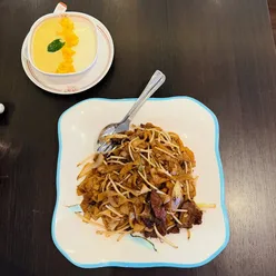 Beef ho fun and mango steamed milk pudding at Four Happiness & Sweet Honey Desserts in Leeds, showcasing authentic Cantonese cuisine.