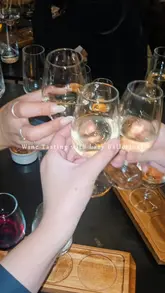 A short, handheld-style reel capturing a wine tasting experience at a venue called Lazy Ballerinas. The video features close-up shots of wine glasses, a tasting flight, and various small plates including bao buns, fries, and a burrata salad.