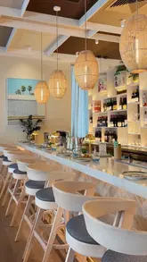 A polished, aesthetic montage showcasing a variety of Asian dishes and the interior of a restaurant called Huo in Belsize Village. The video focuses on the presentation of the food and the calm, airy atmosphere of the venue.