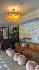 A couple showcases their stay at The Hoxton Hotel in Edinburgh, highlighting the room, the lobby, the bar with a live DJ, and the private cinema.