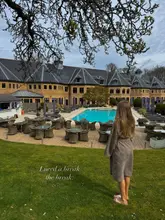 Here are a few options for SEO alt text, keeping within the 125-character limit and focusing on description and keywords:

**Option 1 (General, if showing the hotel/grounds):**
"Grand Pennyhill Park luxury hotel & spa exterior, set in idyllic UK countryside. Perfect London area spa break." (123 characters)

**Option 2 (If showing someone relaxing):**
"Person enjoying the luxury Pennyhill Park spa hotel, nestled in idyllic UK countryside. A perfect London area spa break." (124 characters)

**Option 3 (Slightly more emphasis on "charm"):**
"Pennyhill Park luxury spa hotel in the charming UK countryside. Ideal for a relaxing staycation or spa break near London." (125 characters)