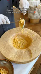 A polished, aesthetic montage of high-end French dishes being prepared and served, including pasta in a cheese wheel, steak, salad, and chocolate mousse, set in a restaurant in Mayfair.