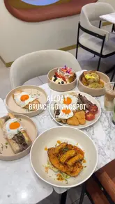 A montage-style reel showcasing the brunch menu at Nour in Walthamstow, featuring close-ups of various dishes like french toast, steak sandwiches, and prawn rolls, alongside shots of the venue's interior.