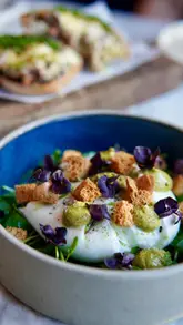 A high-quality, polished montage showcasing a dining experience at a restaurant. The video features a variety of dishes including focaccia, arancini, beef on toast, burrata, salmon, and steak, alongside a cocktail. The editing is smooth and professional, focusing on the presentation of the food and the inviting atmosphere of the venue.
