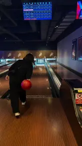 A montage video showcasing a family visit to All Star Lanes, featuring bowling gameplay, the shoe rental area, and a sharing platter of food including pizza, fries, and wings.