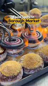 A fast-paced montage video showcasing various popular food vendors at Borough Market in London, including donuts, paella, chips, and tacos.