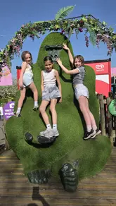 A family-focused reel showcasing a day out at Chessington World of Adventures, featuring clips of children exploring the park, interacting with statues, riding attractions, and ending with a glass of wine.