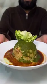 A review-style video showcasing various Pakistani dishes at Shazia's Street Food in Bury, Manchester. The video features close-up shots of the food being prepared and served, including a 'cutlas' (Pakistani scotch egg), seekh kebab wraps, pakora curry, biryani, daal, and chicken curry.