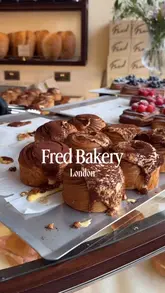 A short, polished montage showcasing the interior and various pastries, sandwiches, and coffee at Fred Bakery in London.