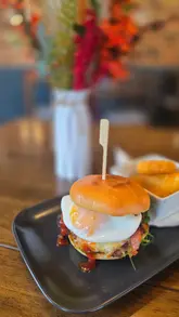 A montage of breakfast dishes at The Shakespeare Inn, featuring a menu, a cup of tea, and various breakfast items including a shakshuka, a brunch burger, and a breakfast burrito.