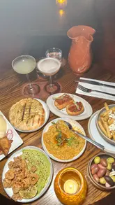 A montage of cocktails and Mediterranean mezze dishes at Kamara Cocktail Bar in Soho, featuring close-ups of food and drinks.