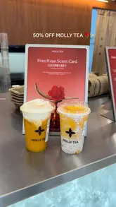 A short, fast-paced promotional video for Molly Tea, showcasing their jasmine-based drinks, branded packaging, and a special promotional offer involving a rose-scented card. The video features quick cuts of the drinks being prepared and held, highlighting the aesthetic appeal of the brand.