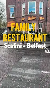 A vlog-style review of Scalini restaurant in Belfast, focusing on its suitability for families. The video features a tour of the menu, including the kids' options, and showcases various dishes like garlic bread, pizza, and desserts.