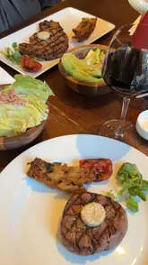 A video review of a midweek set menu at Miller & Carter, featuring the creator and friends enjoying cocktails, starters, and steak in a cosy restaurant setting.