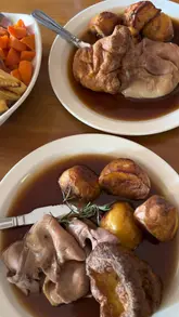 A montage video showcasing The Farmers Home, a traditional country pub in Durley. The video features exterior shots of the building and garden, interior shots of the dining area with a fireplace, and close-ups of various roast dinner plates and desserts.