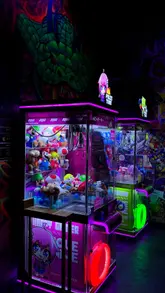 A fast-paced montage showcasing the interior and atmosphere of NQ64, an arcade bar. The video highlights various retro arcade machines, neon lighting, and the social environment, effectively communicating the venue's unique selling point as a place for gaming and drinks.