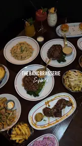 A polished montage showcasing a variety of dishes and drinks at The Banc Brasserie in Enfield, featuring close-ups of steaks, pasta, sliders, and cocktails.
