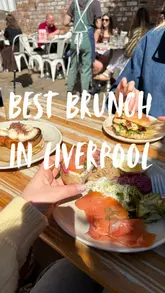 A short, montage-style video showcasing a brunch venue in Liverpool. It features close-ups of various dishes like French toast, salmon toast, and a burger, alongside shots of iced drinks and the venue's outdoor garden seating area.