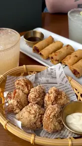 A montage showcasing the exterior, interior, drinks, and food at 'Take Your Time' restaurant in Reading, featuring dishes like spring rolls, crispy chicken, a char siu pork pineapple bun, and vermicelli.