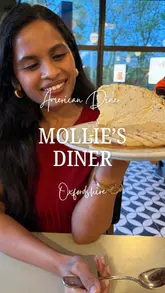 A couple visits Mollie's Diner in Oxfordshire, providing a review of the venue's American-style menu, including burgers, sides, and desserts, while highlighting the diner's atmosphere and drive-thru service.