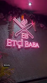 A montage-style video showcasing a variety of Turkish dishes and drinks at Etci Baba, including mezze, lamb tacos, and a large mixed grill platter.