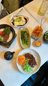 A montage of various dishes at Pot and Rice in London, featuring claypot rice, noodles, and a dessert, presented with text overlays.