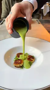 The video provides a tour of the Seahorse restaurant and the Grand Central Hotel in Belfast. It features close-up shots of various dishes, including scallops, chicken, and dessert, as well as the restaurant interior, the hotel exterior, a cocktail, the hotel room, and a breakfast buffet.
