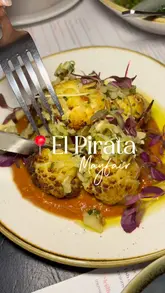 A montage of various Spanish tapas dishes, cocktails, and the exterior/interior of El Pirata in Mayfair, set to music.