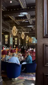 The video provides a tour of The Grand Hotel in Birmingham, highlighting the opulent interior of the Madeleine Bar, the afternoon tea service, the hotel's grand staircase, a guest room, and the city view.
