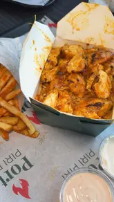 A vlog-style review of Porto Piri Piri in Glasgow, showcasing the menu, ordering process, and various chicken dishes including a rice box, wings, and a burger.