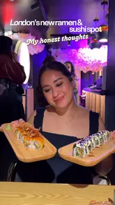The video is a review of a new ramen and sushi restaurant in London. The creator provides a balanced critique of the food, praising the ramen while expressing reservations about the sushi. The video features shots of the interior, including neon lighting and a wall covered in post-it notes, alongside close-ups of the dishes.