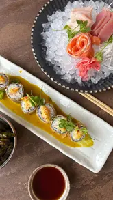 A montage-style reel showcasing a visit to Hemisphere restaurant, featuring close-ups of sushi, sashimi, edamame, and a sizzling steak hot plate, interspersed with shots of the venue interior and wine service.