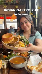 A creator visits 'The Great Indian' in London, a gastro pub blending British pub culture with Indian cuisine. The video features a tour of the venue, a look at the menu, and close-ups of various dishes including a Sunday roast, prawns, and mocktails, with the creator providing commentary on her experience.
