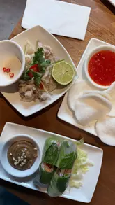 The creator visits a Vietnamese restaurant to highlight their extensive gluten-free menu. The video features a personal narrative about dining with coeliac disease, followed by a tour of the menu and a variety of dishes including summer rolls, baby squid, pho, and a pandan waffle.