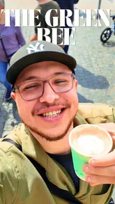 A creator visits 'The Green Bee Coffee Co.', a coffee van located in Enfield, to review their coffee. He showcases the van, the menu, and samples a Spanish latte and an espresso.