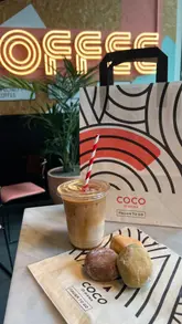 A promotional reel for Coco di Mama highlighting their 15th-anniversary £2 coffee offer. The video features quick cuts of iced coffee, bombolinis, and pasta dishes, alongside shots of the venue's interior and branding.