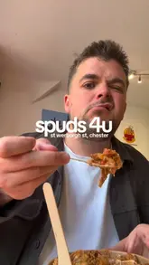 A short vlog-style review of a baked potato shop in Chester, featuring the exterior, menu, and close-ups of the food being eaten by the creator and a companion.