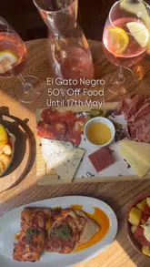 A montage of various tapas dishes, sangria, and the interior of El Gato Negro restaurant, highlighting the food and the refurbished decor.