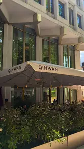 A short, aesthetic montage showcasing the interior and menu offerings of Qinwan Cafe at The Chancery Rosewood. The video features slow, deliberate shots of coffee, tea, dates, and cake, emphasizing the refined atmosphere and high-end presentation of the products.