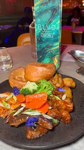 A promotional reel showcasing the Sunday roast offering at BLVD in Manchester, highlighting the venue's atmosphere, cocktails, starters, and sharing roast platters.