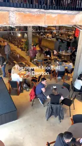 A tour of Hatters Food & Drinks Hall in Denton, showcasing the interior, seating areas, and various food offerings including chicken and waffles, slow-cooked beef on brioche, and gambas al pil pil.