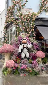 A montage of various floral installations across Chelsea for the 'Chelsea in Bloom' festival, featuring space-themed designs like UFOs, planets, and aliens.