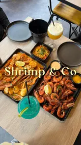 A promotional video for Shrimp & Co in Brixton, showcasing their seafood boil dishes and mocktails. The video features shots of the restaurant interior, the menu, and close-ups of the food being prepared and eaten.