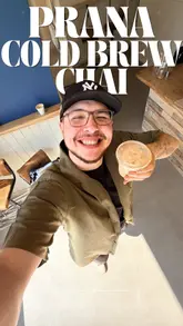 A creator visits Blue Door Coffee to try their cold brew chai. The video features a tour of the cafe, a look at the preparation of the drink, and the creator's reaction to the taste.