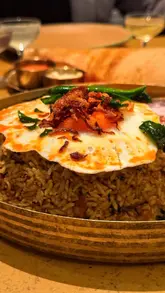 A fast-paced, engaging reel showcasing a visit to the new Hoppers location in Shoreditch. The video features quick cuts of the exterior, interior, various dishes including a beef short rib biryani, and cocktails, highlighting the venue's atmosphere and suitability for a date night.