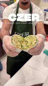 A creator visits a popular London street food spot, Czer, to test if their viral chicken caesar wrap is worth the long queue. The video documents the wait, the preparation process, and provides a taste test review.